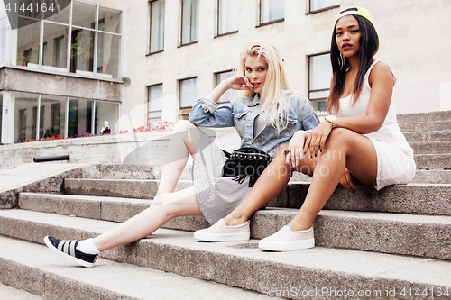 Image of Two teenage girls infront of university building smiling, having fun, lifestyle people concept