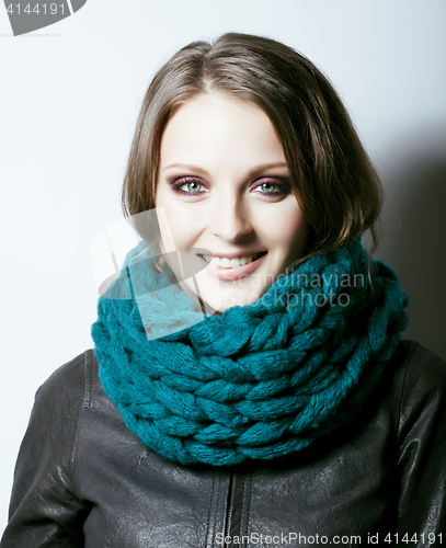 Image of young pretty real woman in sweater and scarf all over her face s