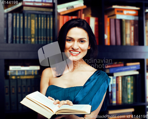 Image of portrait of beauty young brunette woman reading book in library smiling, muslim girl in education, lifestyle people concept