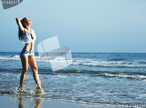 Image of real blonde girl along on seacost walking, healthy at sunrise, l