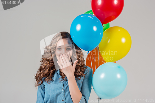 Image of girl with bunch of colorful balloons