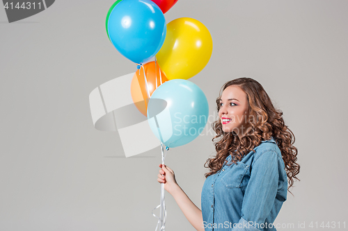 Image of girl with bunch of colorful balloons