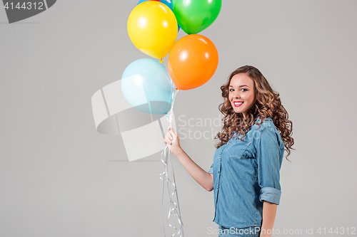 Image of girl with bunch of colorful balloons