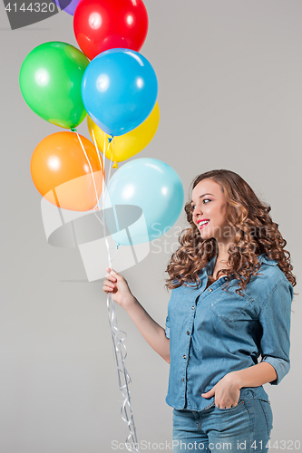 Image of girl with bunch of colorful balloons