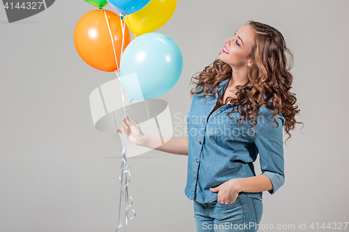 Image of girl with bunch of colorful balloons