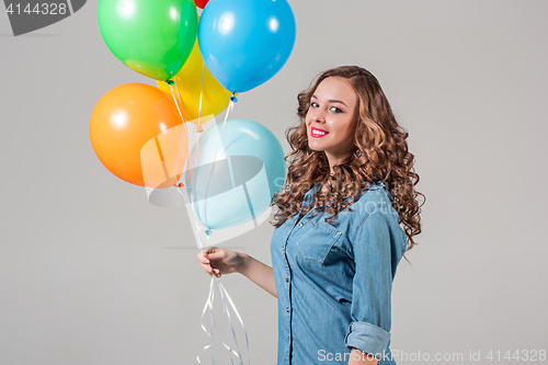 Image of girl with bunch of colorful balloons