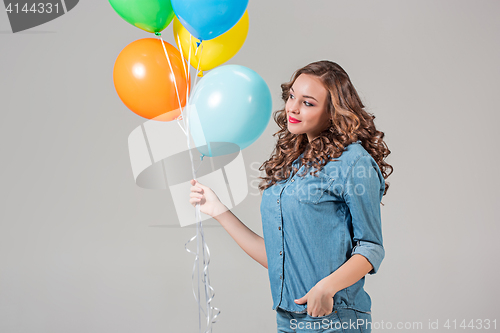 Image of girl with bunch of colorful balloons