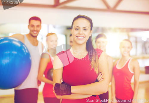 Image of woman standing in front of the group in gym