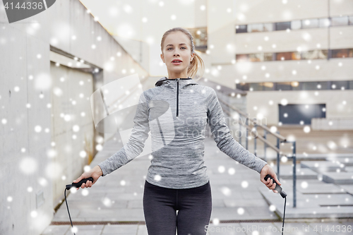 Image of woman exercising with jump-rope outdoors