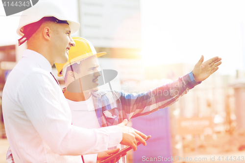 Image of builder and architect with tablet pc outdoors