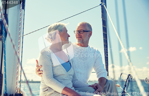 Image of senior couple hugging on sail boat or yacht in sea