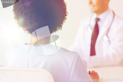 Image of close up of african doctor at hospital from back