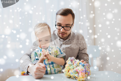 Image of father and son playing with ball clay at home