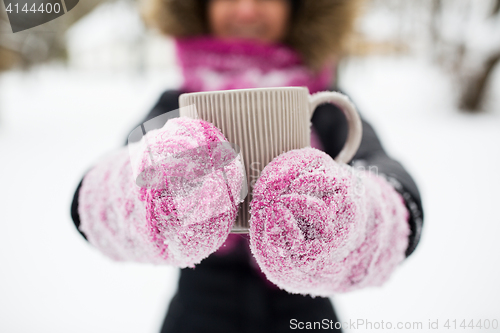 Image of close up of woman with tea mug outdoors in winter