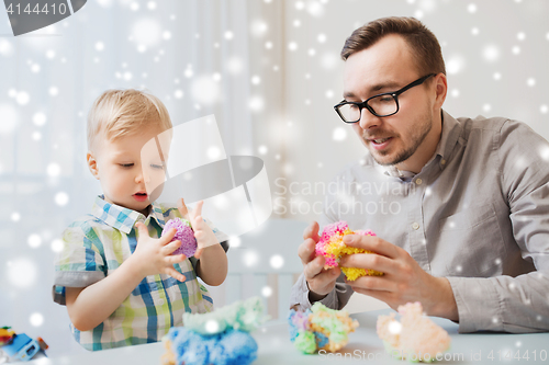 Image of father and son playing with ball clay at home