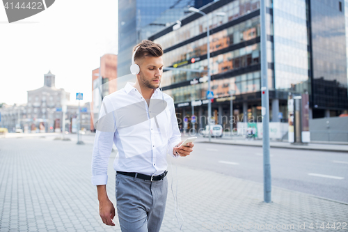 Image of man with headphones and smartphone listening music