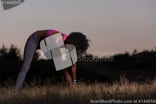 Image of black woman is doing stretching exercise relaxing and warm up