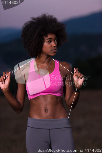 Image of portrait of african american woman jogging in nature