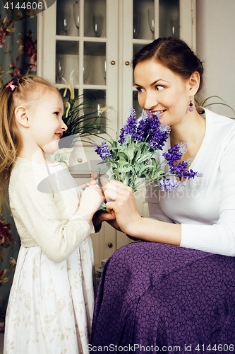 Image of young mother with daughter at luxury home interior vintage