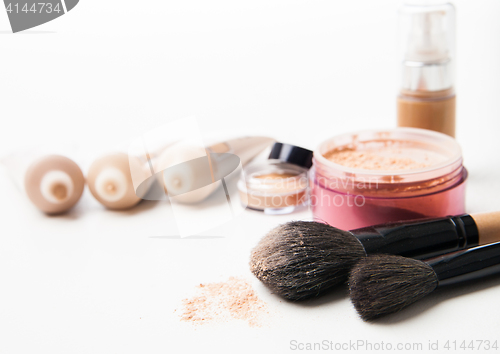 Image of Powder, foundation and brushes on the white background