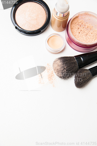 Image of Powder, foundation and brushes on the white background