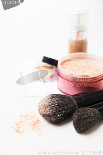 Image of Powder, foundation and brushes on the white background