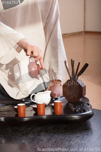 Image of Young man holds a Chinese tea ceremony