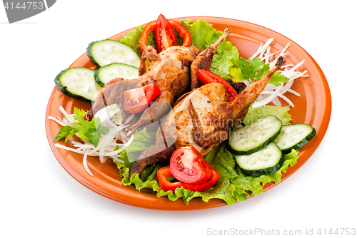 Image of Two whole quail with cucumber, tomatoes and onion