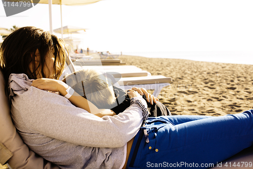 Image of young mother with son resting on sea coast, happy family together talking, lifestyle people concept