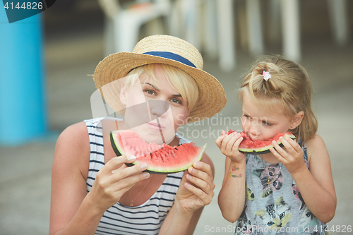 Image of Mother And Daughter Enjoying Slices Of WaterMelon
