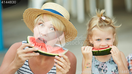 Image of Mother And Daughter Enjoying Slices Of WaterMelon