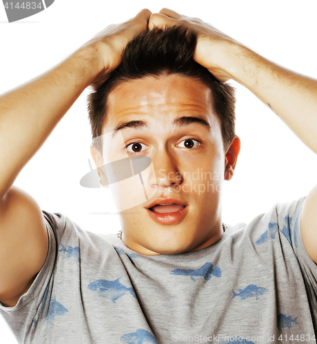 Image of Young attractive handsome man holding hands on his head emotiona