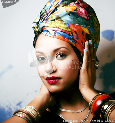 Image of beauty bright african woman with creative make up, shawl on head