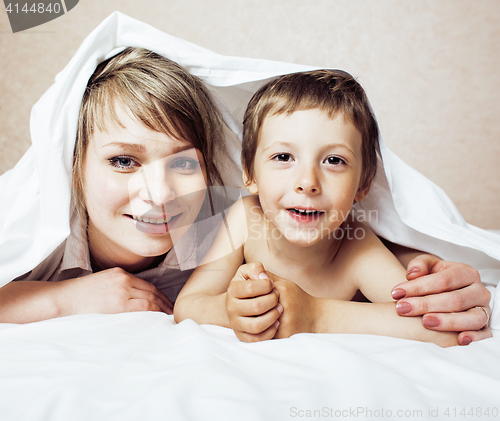 Image of young blond woman with little boy in bed, mother and son, happy familyyoung blond woman with little boy in bed, mother and son, happy family