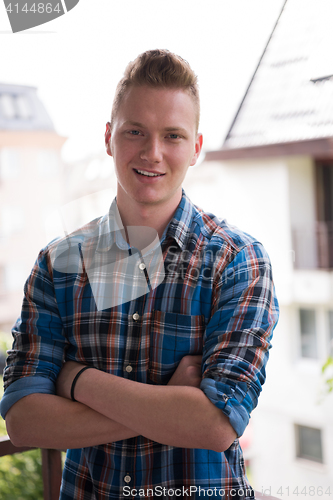 Image of man standing at balcony