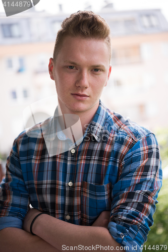 Image of man standing at balcony