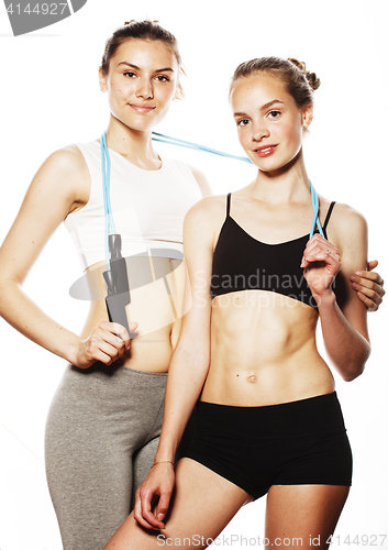 Image of two sport girls measuring themselves isolated on white