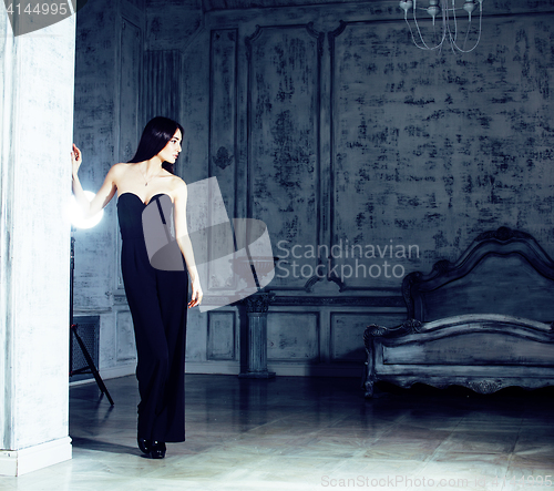 Image of beauty young brunette woman in luxury home interior, fairy bedroom grey stylish