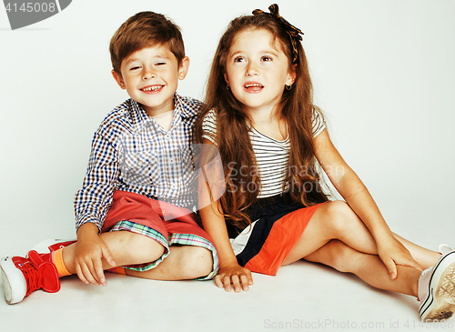 Image of little cute boy and girl hugging playing on white background, ha