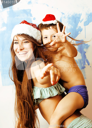 Image of funny family in red hats celebrating new year, mother with son happy smiling, lifestyle people concept