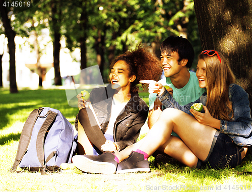 Image of cute group of teenages at the building of university with books 