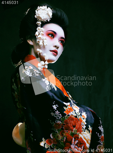 Image of geisha in kimono on black