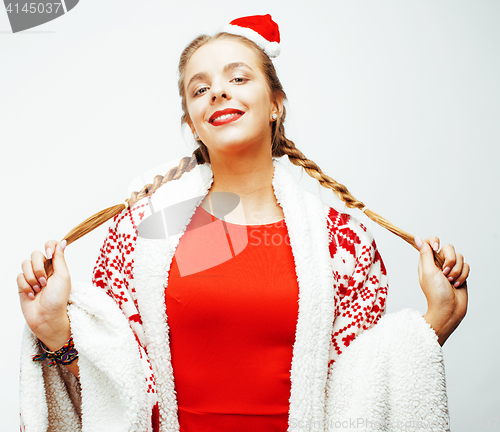 Image of young pretty happy smiling blond woman on christmas in santas red hat and holiday decorated plaid, lifestyle people concept