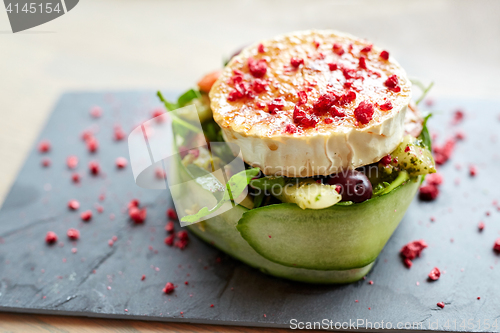 Image of goat cheese salad with vegetables at restaurant