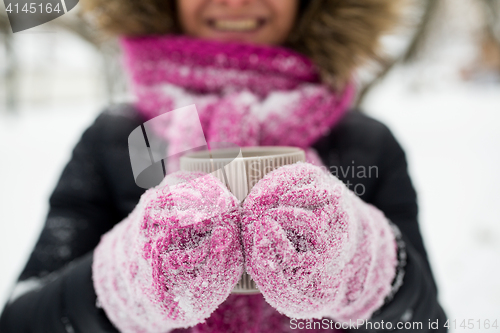 Image of close up of woman with tea mug outdoors in winter