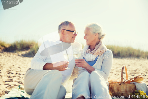 Image of happy senior couple talking on summer beach