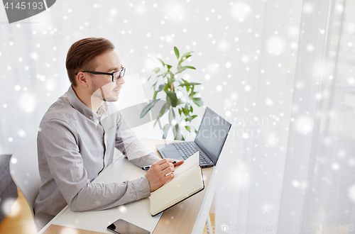 Image of creative man or businessman writing to notebook