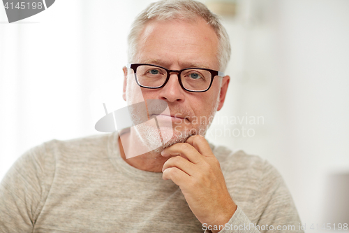 Image of close up of senior man in glasses thinking