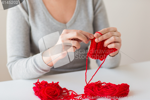 Image of woman hands knitting with needles and yarn