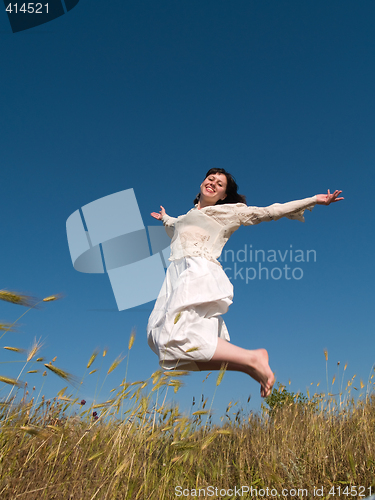 Image of Happy Jumping Girl on Field